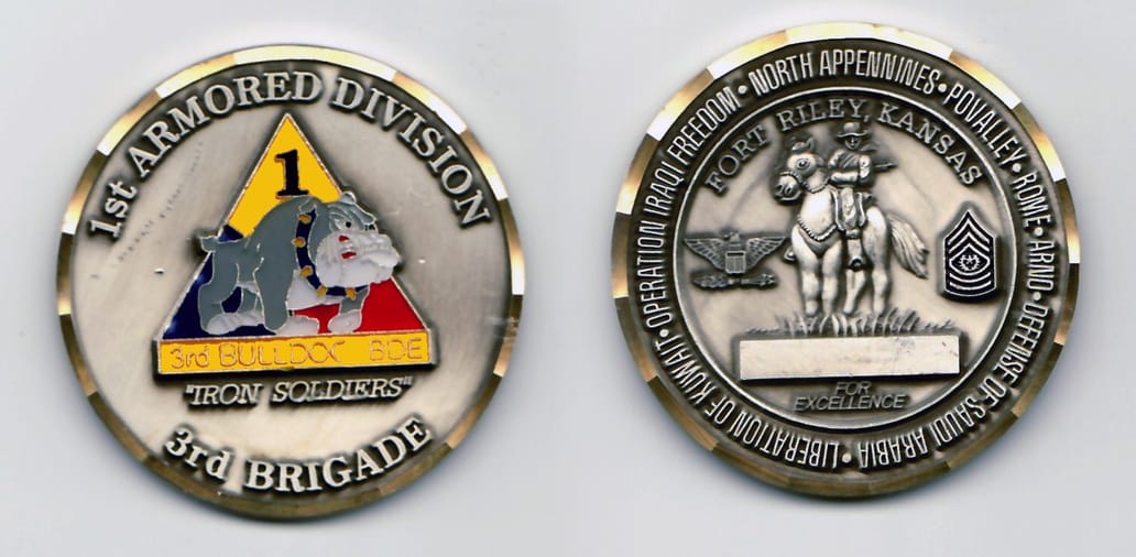 Round shaped, pewter colored coin 2 inches in diameter with a gold colored rim.