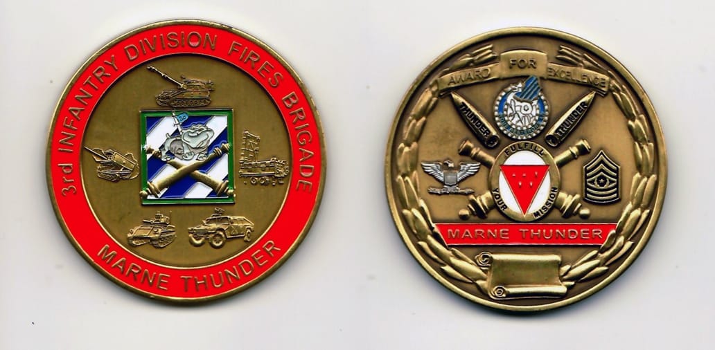 Round shaped, gold colored coin 2 inches in diameter.