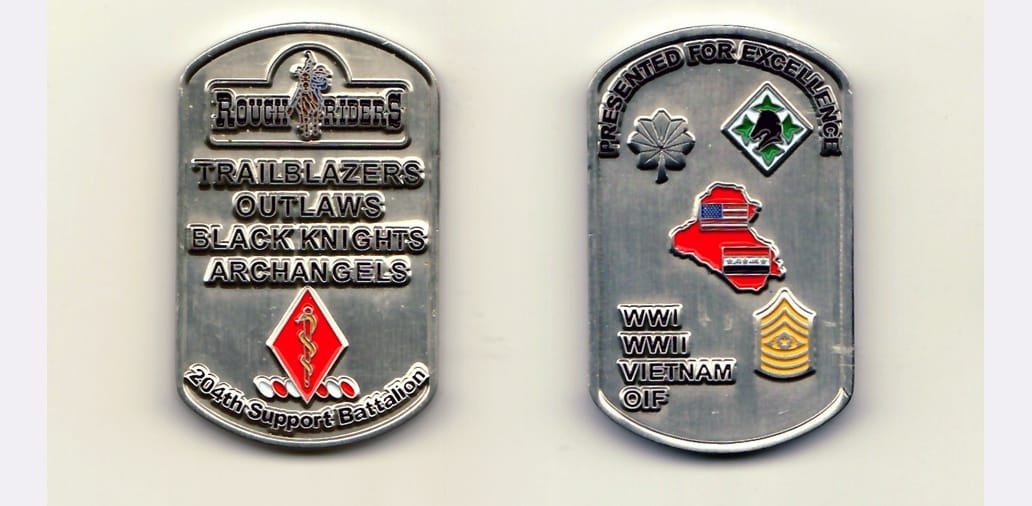 Dog tag shaped, pewter colored coin 1-3/4 inches high.