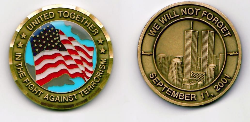 Round shaped, brass colored coin with a gold edge 1-9/16 inches in diameter.