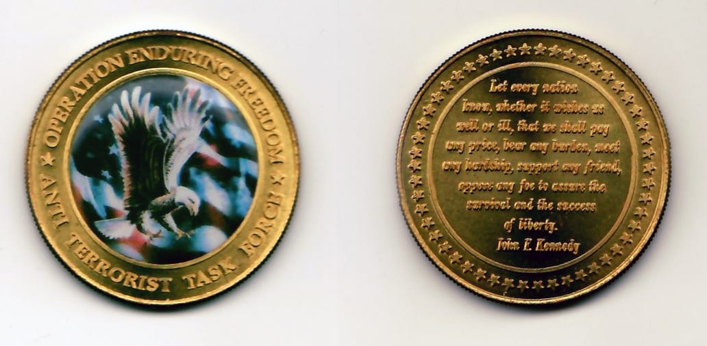 Round shaped, gold colored coin 1-1/2 inches in diameter.