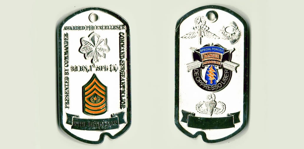 Dog tag shaped, chrome colored coin 1-5/16 inches Wide x 2-7/16 inches high.