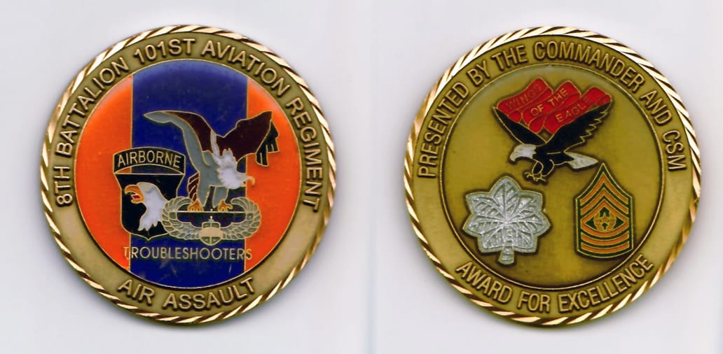 Round shaped, braass colored coin 2 inches in diameter.