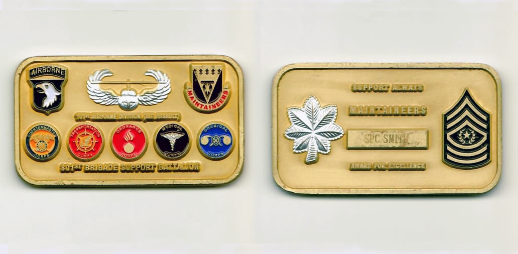 Retangular shaped, gold colored coin with rounded egdes, 2-5/8 inches wide x 1-1/2 inches high.