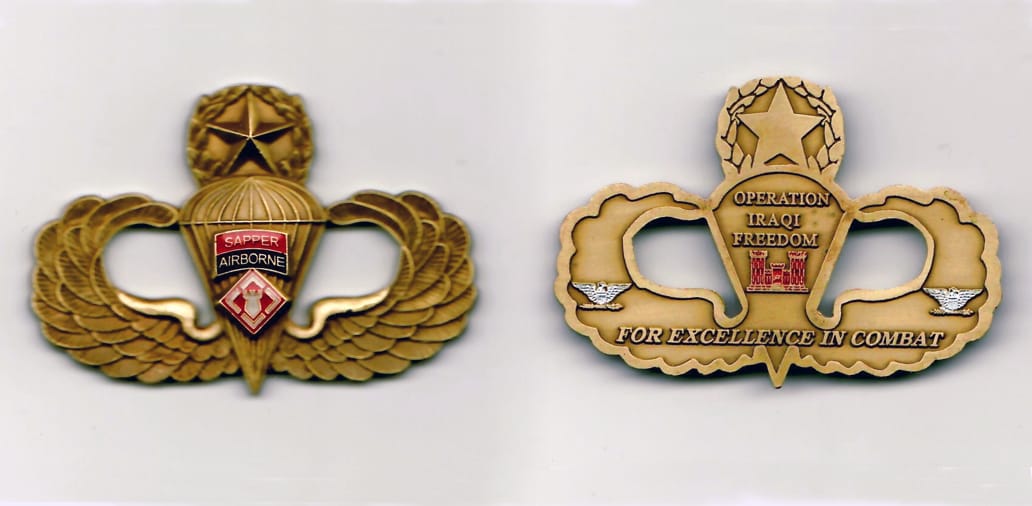 Master airborne wings shaped, antique brass colored coin with cut out areas,  2-1/4 inches wide x 2-5/8 inches high.