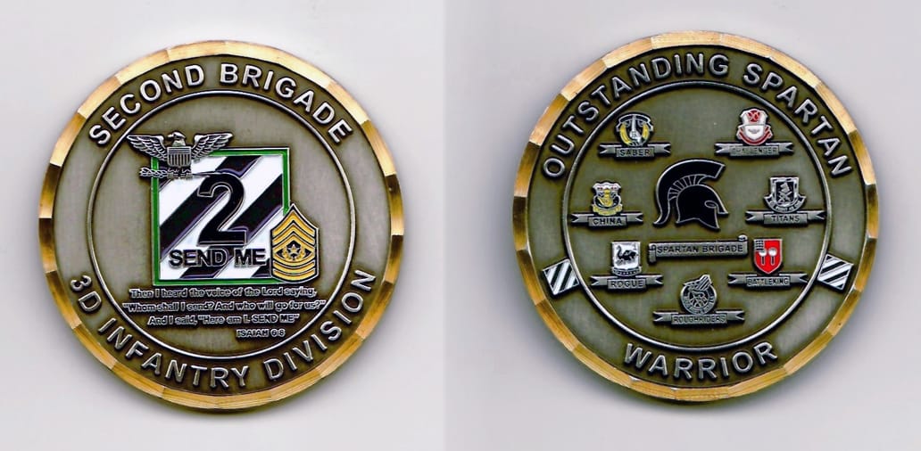 Round shaped, pewter colored coin with a gold colored rim, 2 inches in diameter.