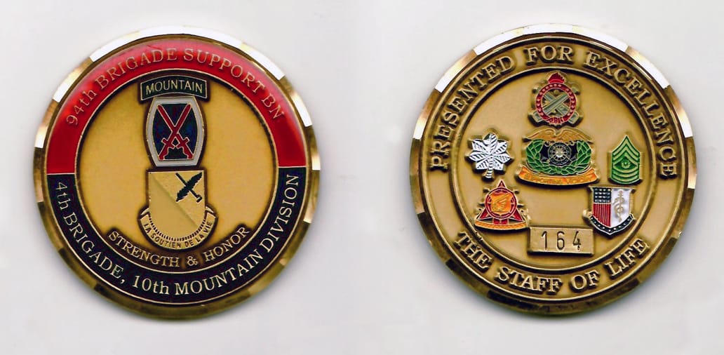 Round shaped, brass colored coin with gold colored rim, 2 inches in diameter.