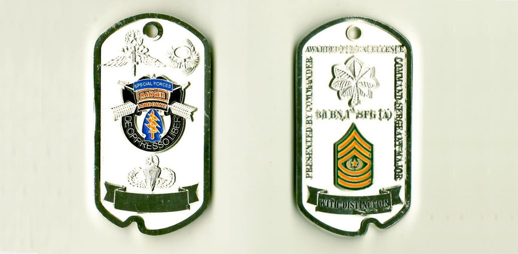 Dog tag shaped, chrome colored coin, 1-1/4 inches wide x 2-1/2 inches high.