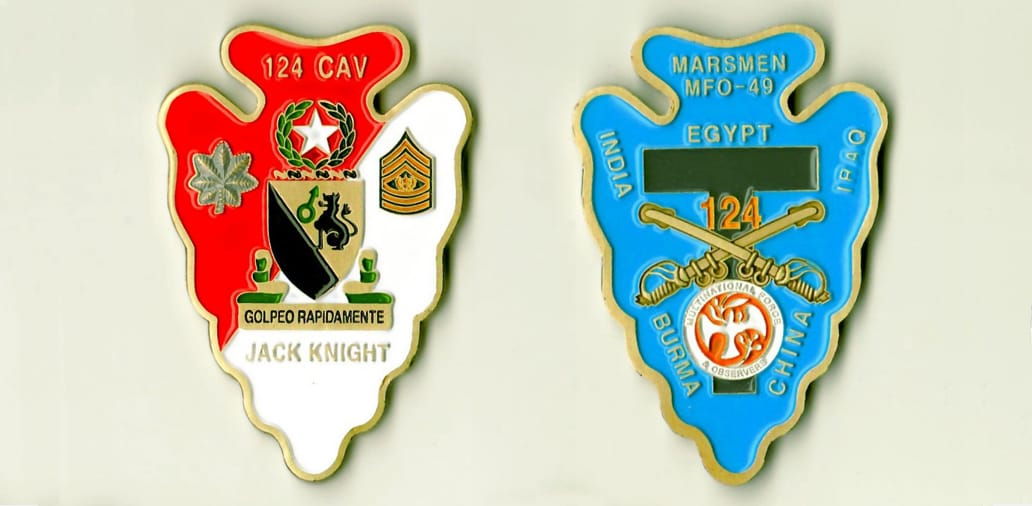 Arrowhead shaped, gold colored coin 1-5/8 inches wide x 2-1/2 inches high.