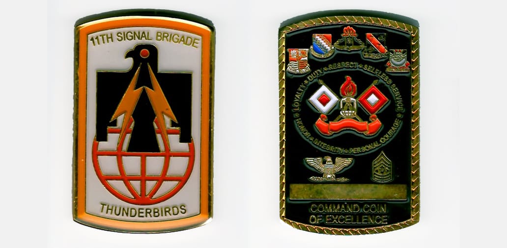 Retangular shaped with outward bowing top and bottom, gold colored coin 1-3/8 inches wide x 2-1/4 inches high.