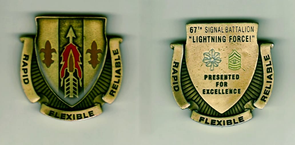 Shield shaped with banner surrounding sides and bottom, antique brass colored coin, 1-9/16 inches wide x 1-9/16 inches h...