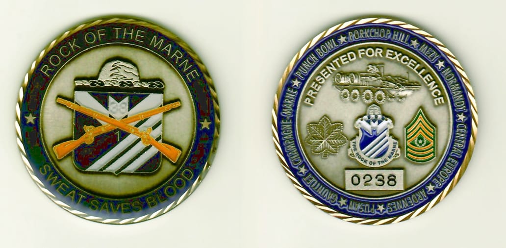 Round shaped, pewter colored coin with brass rim, 1-15/16 inches in diameter.