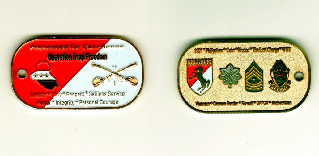 Dog taged shaped, gold colored coin 2 inches wide x 1-1/16 inches high.