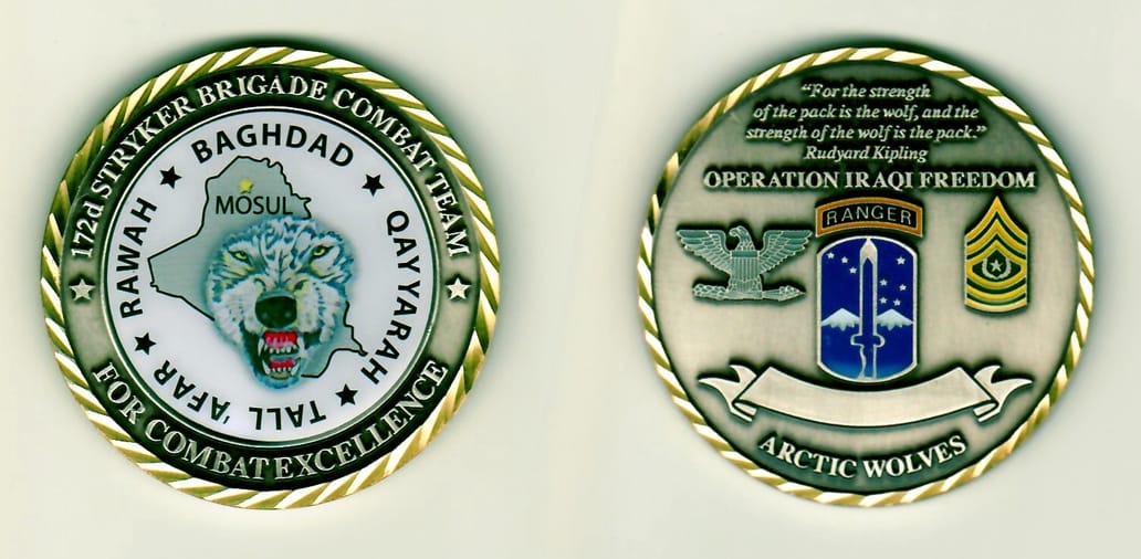 Round shaped, pewter colored coin with gold colored rim, 2 inches in diameter.