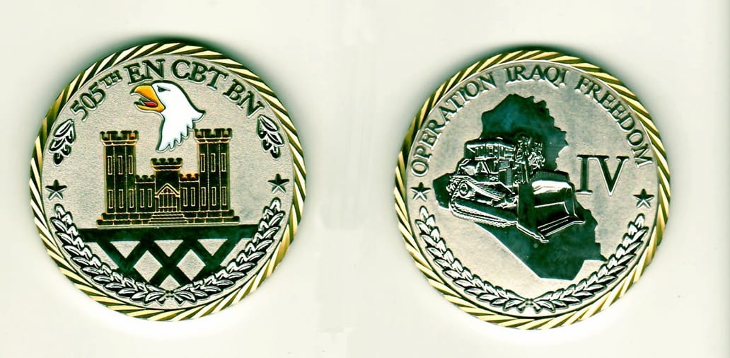 Round shaped, chrome colored coin with gold rim, 2 inches in diameter.