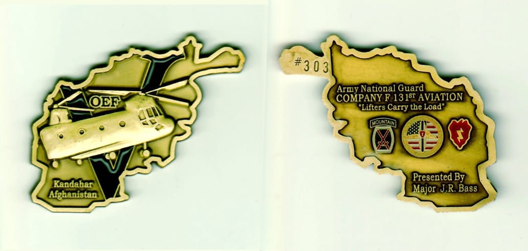 Afghanistan shaped, antique brass colored coin 2-3/4 inches iwide x 1-3/4 inches high.