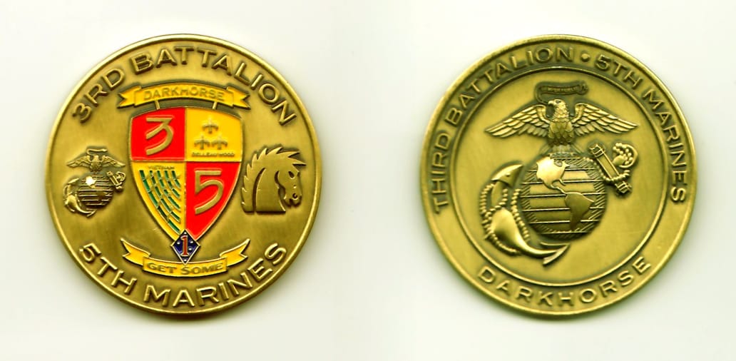 Round shaped, brushed gold colored coin, 1-3/4 inches in diameter.