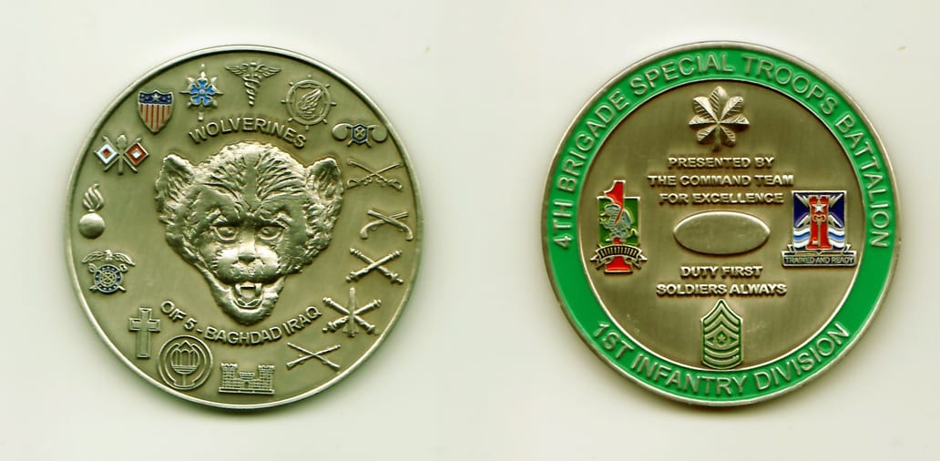 Round shaped, pewter colored coin, 2 inches in diameter.