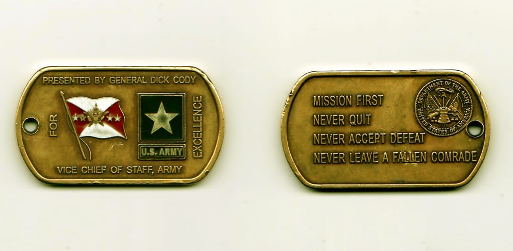 DogTag shaped, bronze colored coin, 2 -1/4 inches wide x 1-1/4 inches high.