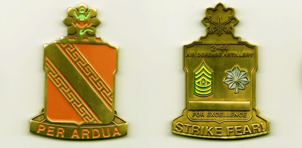 Squared shield shaped, with banner below and flower mounted atop, gold colored coin, 2-1/4 inches wide x 2-15/16 inches ...