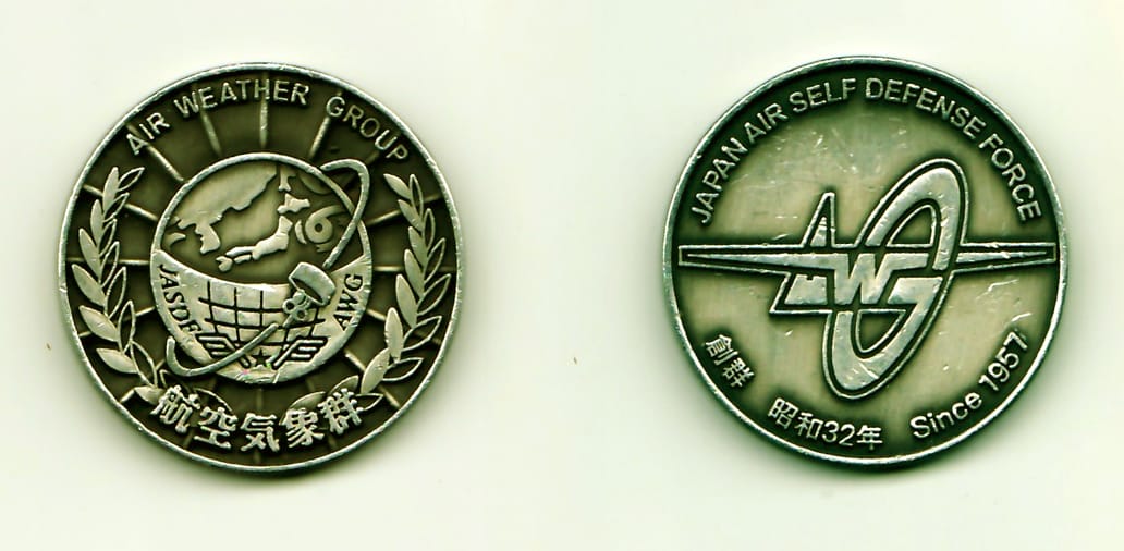 Round shaped, pewter colored coin, 1-9/16 inches in diameter.