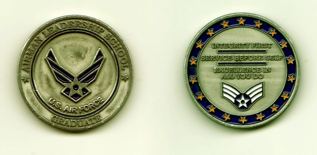 Round shaped, pewter colored coin, 1-5/16 inches in diameter.