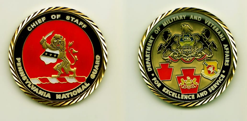 Round shaped, golds colored coin, 1-7/8 inches in diameter.