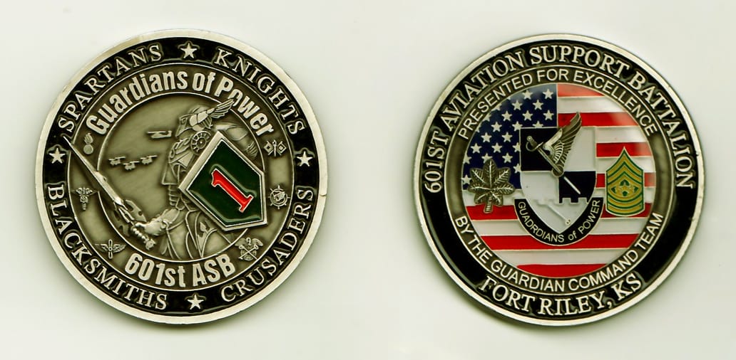 Round shaped, pewter colored coin, 1-7/8 inches in diameter.