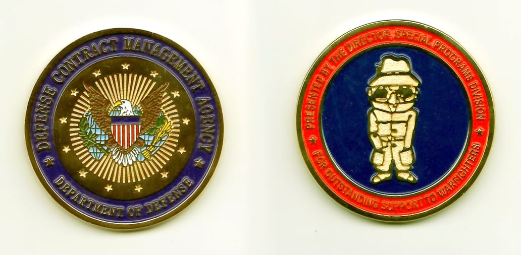 Round shaped, gold colored coin, 1-11/16 inches in diameter.