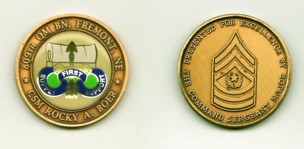 Round shaped, gold colored, ribbed edge coin, 1-1/2 inches in diameter.