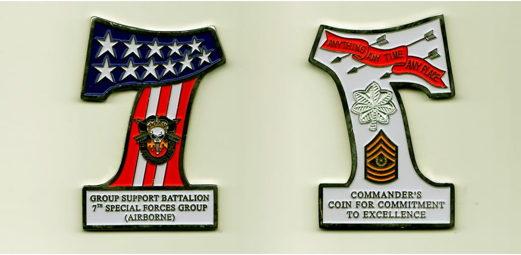 Number 7 shaped, silver colored coin, 2-3/4 inches high x 1-15/16 inches wide.