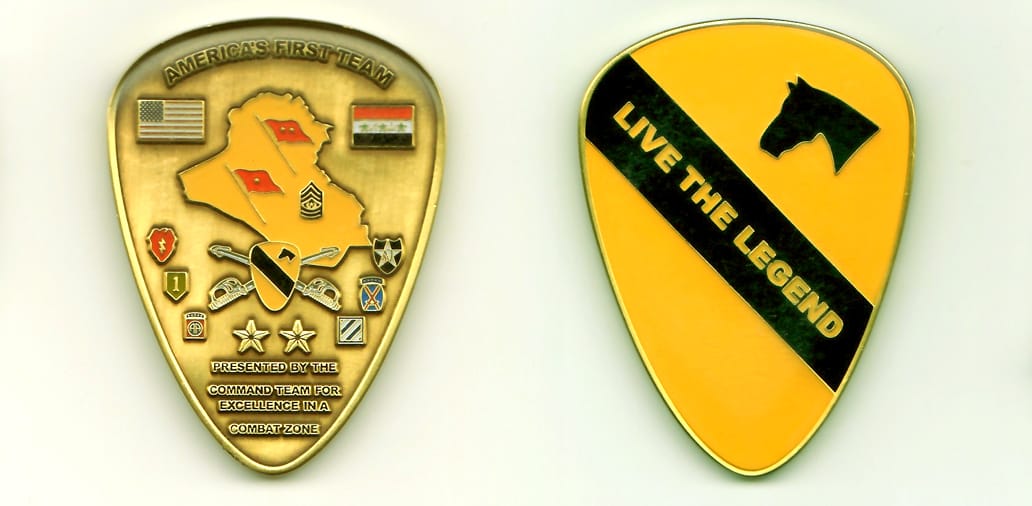 Shield shaped, gold colored coin, with rounded top, 2-1/4 inches high x 1-1/2 inches wide.