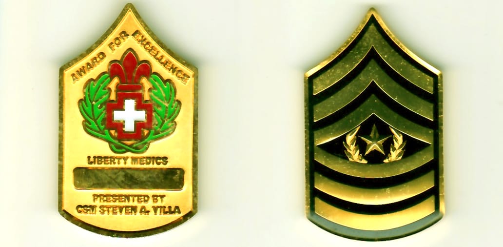 CSM chevron shaped, gold colored coin, 2 inches high x 1-3/8 inches wide