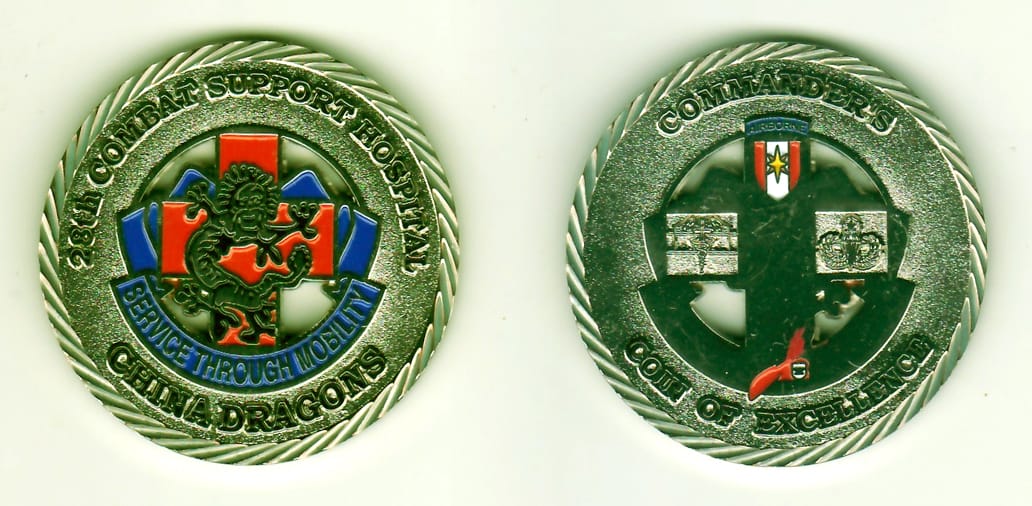 Round shaped, chrome colored coin, 2-7/8 inches in diameter.