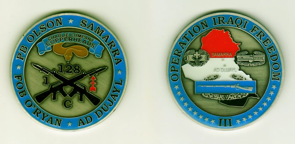 Round shaped, pewter colored coin, 2 inches in diameter.