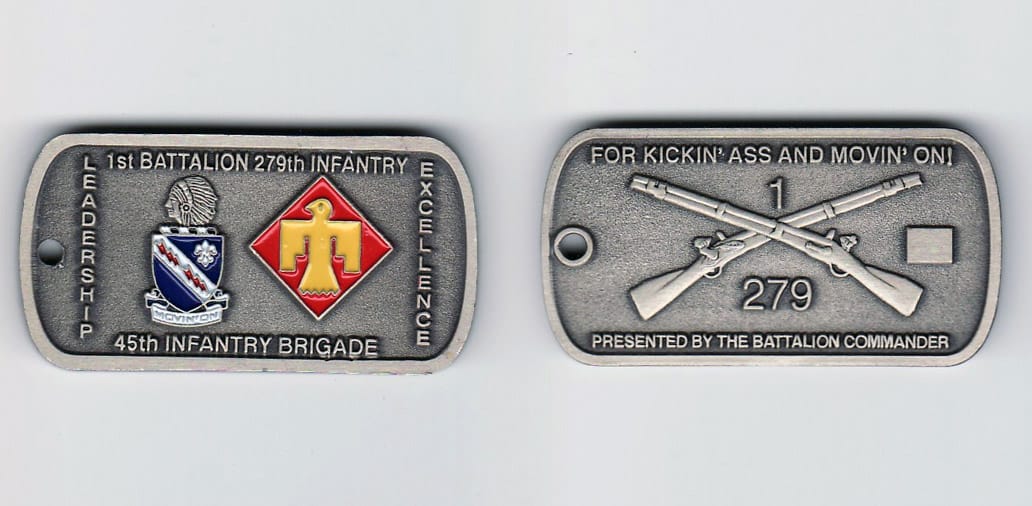 Dog Tag shaped, antique silver colored coin, 2- 15/16 inches wide x 1 inch high.