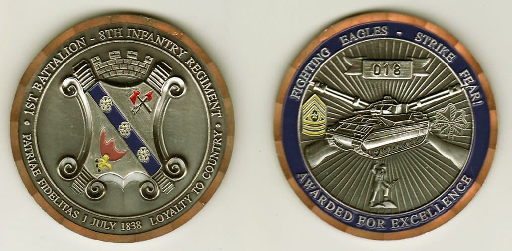 Round shaped, silver colored coin with brass colored rim, 2- 1/8 inches in diameter.