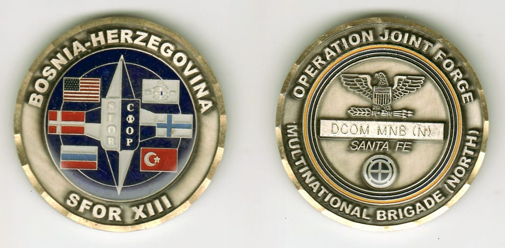 Round shaped, silver colored coin, 2- 1/8 inches in diameter.