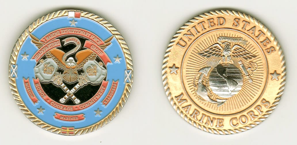 Round shaped, brass colored coin w/silver rim, 2 inches in diameter.