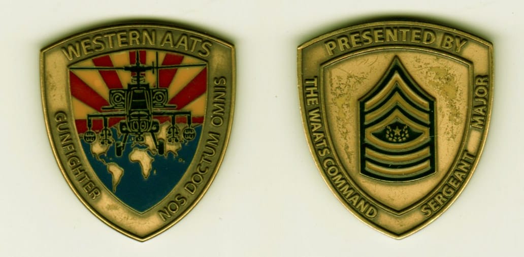 Shield shaped, antique brass colored coin, 1-1/2 inches wide x 1-1/2 inches high