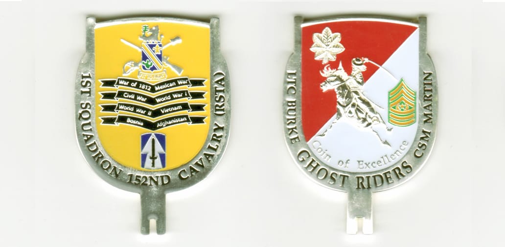 Shield shaped with key protusion beneath, silver colored coin, 2-1/4 inches ihigh x 1-1/2 inches wide.