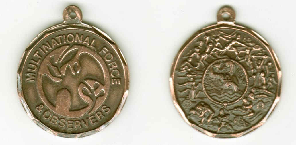 Round shaped, copper colored coin with chain attachment ring above , 1-3/8 inches in diameter.