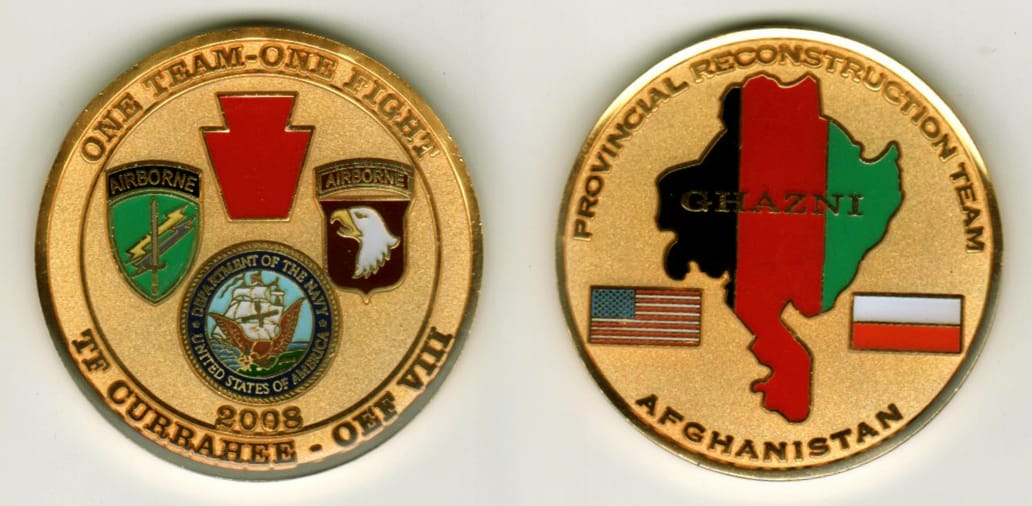 Round shaped, gold colored coin, 1-13/16  inches in diameter.