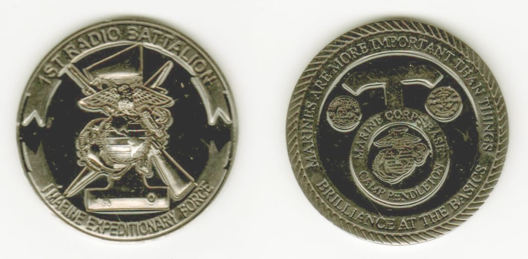 Round shaped, black metal colored coin, 1-5/8 inches in diameter.