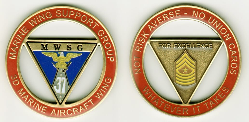 Round shaped with inverted triangle cut out, brass colored coin, 2-1/8 inches in diameter.