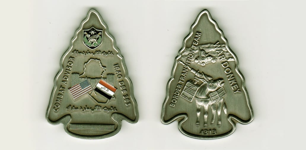 Spearhead shaped, pewter colored coin, 2- 1/4 inches high by 1- 1/2 wide.