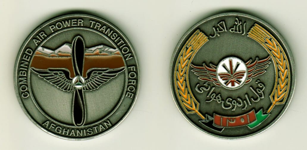 Round shaped, silver colored coin, 1-1/4 inches in diameter.