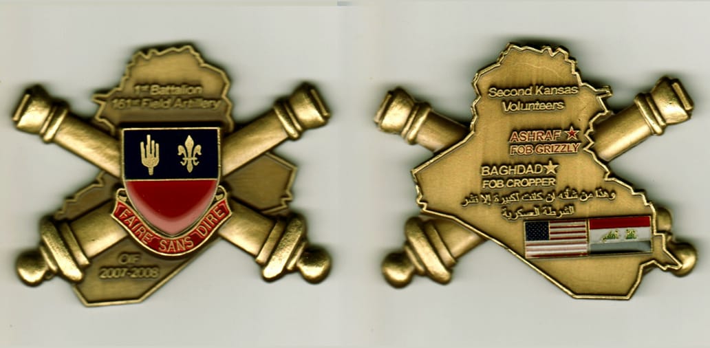 Iraq shaped with Artillery Cannons extended, antique brass colored coin, 2- 1/2 inches wide x 2 inches high.