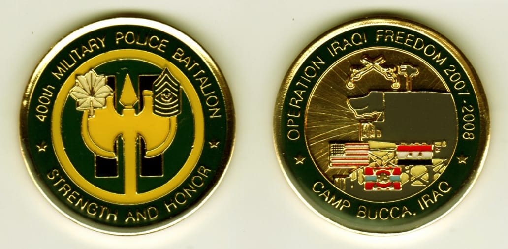 Round shaped, gold colored coin, 1-11/16 inches in diameter.