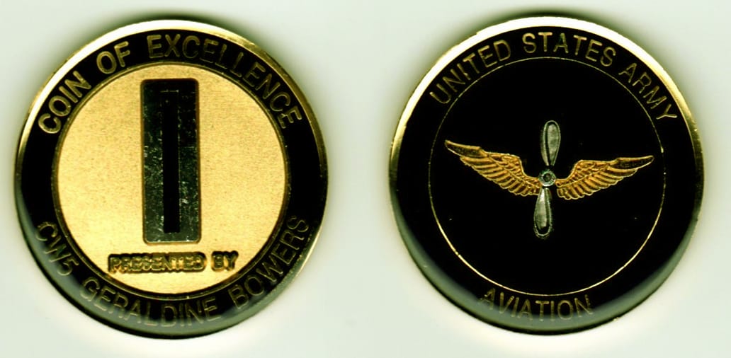 Round shaped, gold colored coin, 1 13/16 inches in diameter.